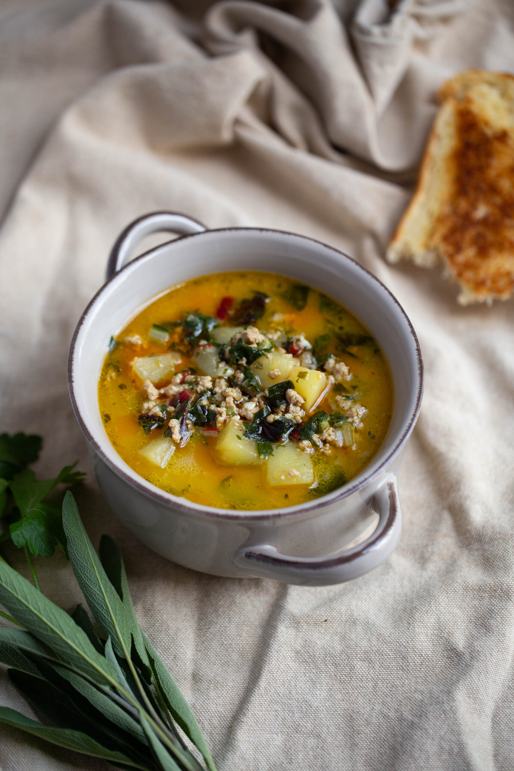 fall turkey soup with fresh herbs and Swiss Chard